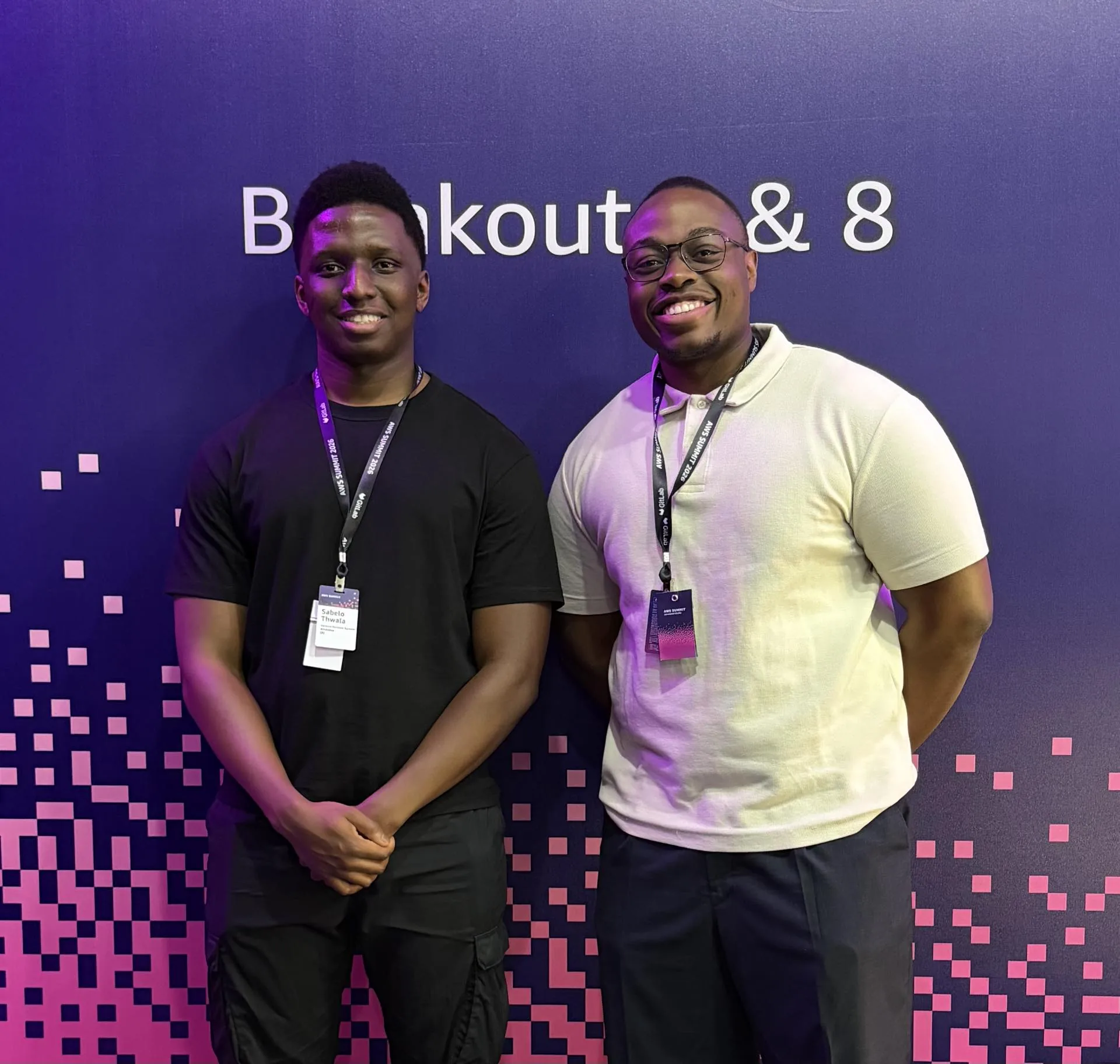 Sabelo and Warren, the two founders of Northbound IT, side by side at the AWS Summit in front of a purple event backdrop